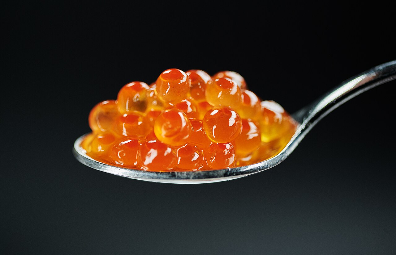 Salmon caviar on a spoon, the ingredient behind Salmon roe