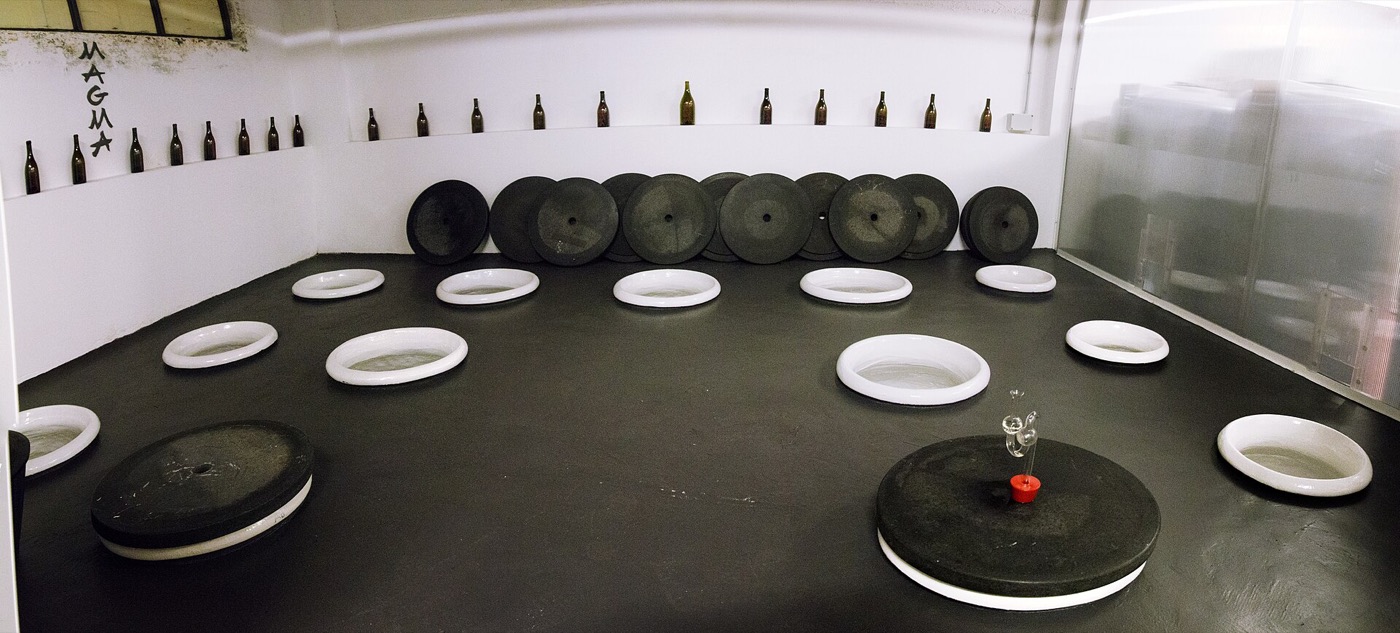 A row of amphorae used for skin-contact winemaking in a Sicilian cellar.
