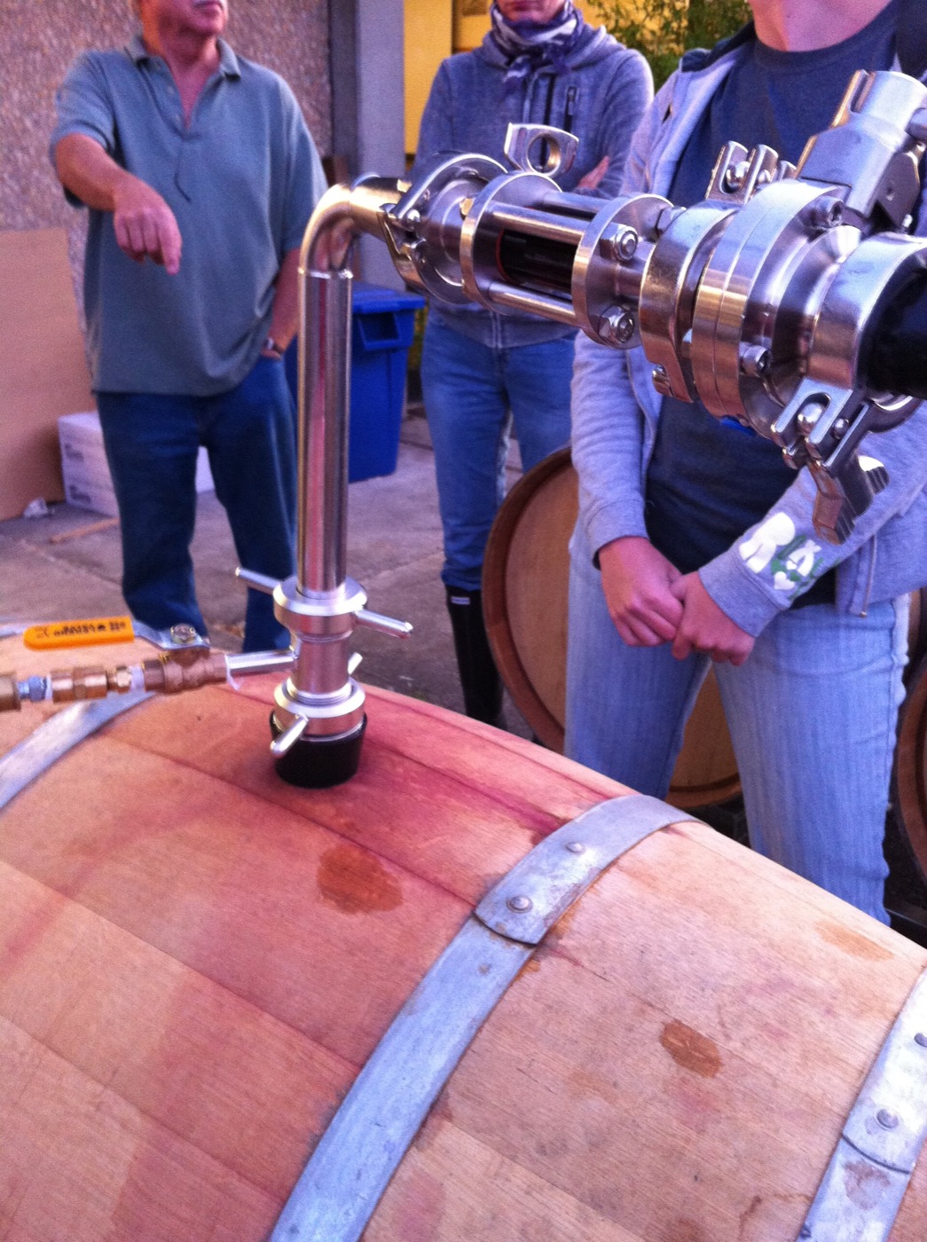 A transparent racking wand used to transfer wine while monitoring sediment.